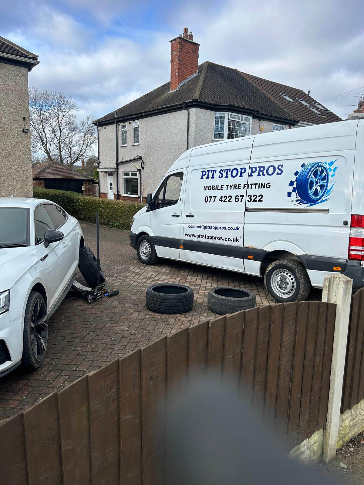 Pit Stop Pros Mobile Van servicing a white sedan on a driveway