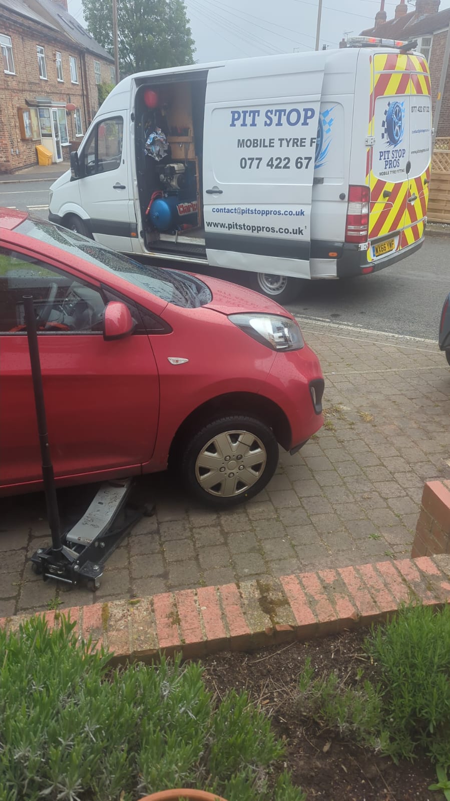 Side profile of white service van on street side door open